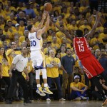 
              Golden State Warriors guard Stephen Curry (30) shoots against Houston Rockets center Clint Capela (15) during the first half of Game 1 of the NBA basketball Western Conference finals in Oakland, Calif., Tuesday, May 19, 2015. (AP Photo/Tony Avelar)
            