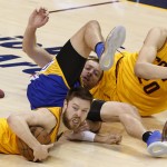 
              Cleveland Cavaliers guard Matthew Dellavedova, bottom, and Golden State Warriors forward David Lee go to the floor for a loose ball during the second half of Game 3 of basketball's NBA Finals in Cleveland, Tuesday, June 9, 2015. (AP Photo/Paul Sancya)
            