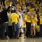 
              Fans cheer after Golden State Warriors guard Stephen Curry, center, scored against the Houston Rockets during the first half of Game 1 of the NBA basketball Western Conference finals in Oakland, Calif., Tuesday, May 19, 2015. (AP Photo/Tony Avelar)
            
