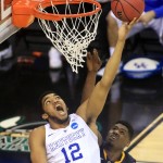 
              FILE - In this March 26, 2015, file photo, Kentucky's Karl-Anthony Towns (12) shoots over West Virginia's Jonathan Holton in the second half in the NCAA college basketball men's regional tournament semifinal in Cleveland. Small ball was the story of the NBA Finals. It might seem temporarily forgotten at the start of the NBA draft. The first three players taken Thursday, June 25, 2015, could easily be a trio of big guys, led by Kentucky's Karl-Anthony Towns.  (AP Photo/Aaron Josefczyk, File)
            