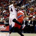 
              Washington Wizards' Bradley Beal, right, reaches for the ball while playing against Atlanta Hawks' Paul Millsap in the second quarter of Game 5 of the second round of the NBA basketball playoffs Wednesday, May 13, 2015, in Atlanta. (AP Photo/John Bazemore)
            