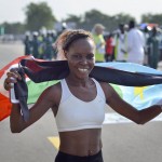 
              In this photo taken Saturday, July 11, 2015, South Sudanese runner Folichiay Faustino Oyo celebrates being the fastest South Sudanese woman in the "Independence Half Marathon" in Juba, South Sudan. Torn by civil war and facing a humanitarian crisis, South Sudan is finding hope on the sporting front: The world’s newest nation is in line for international recognition that would allow it to send a team to next year’s Olympics in Rio de Janeiro. (AP Photo/Jason Patinkin)
            