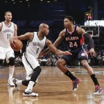 
              Atlanta Hawks' Kent Bazemore (24) defends Brooklyn Nets' Jarrett Jack (0) as teammate Brook Lopez (11) watches during the first half of Game 6 in a first round NBA playoff basketball game Friday, May 1, 2015, in New York. (AP Photo/Frank Franklin II)
            