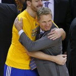 
              Golden State Warriors forward David Lee, left, hugs coach Steve Kerr during the second half of Game 5 of the NBA basketball Western Conference finals against the Houston Rockets in Oakland, Calif., Wednesday, May 27, 2015. The Warriors won 104-90 and advanced to the NBA Finals. (AP Photo/Tony Avelar)
            