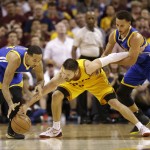 
              Cleveland Cavaliers guard Matthew Dellavedova, center, goes for a loose ball with Golden State Warriors guard Stephen Curry, right, and guard Shaun Livingston during the second half of Game 3 of basketball's NBA Finals in Cleveland, Tuesday, June 9, 2015. (AP Photo/Tony Dejak)
            
