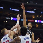 
              San Antonio Spurs forward Tim Duncan, right, shoots as Los Angeles Clippers forward Blake Griffin, left, defends Spurs center Tiago Splitter, second from left, of Brazil, and Clippers center DeAndre Jordan (6) battle during the first half of Game 7 in a first-round NBA basketball playoff series, Saturday, May 2, 2015, in Los Angeles. (AP Photo/Mark J. Terrill)
            