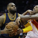 
              Cleveland Cavaliers forward LeBron James (23) is fouled by Atlanta Hawks guard Jeff Teague (0) during the second half in Game 2 of the Eastern Conference finals of the NBA basketball playoffs, Friday, May 22, 2015, in Atlanta. (AP Photo/David Goldman)
            