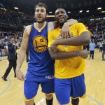 
              Golden State Warriors center Andrew Bogut, left, of Australia, celebrates with Festus Ezeli, of Nigeria, right, after the Warriors beat the Memphis Grizzlies in Game 6 of a second-round NBA basketball Western Conference playoff series Friday, May 15, 2015, in Memphis, Tenn. The Warriors won 108-95 to win the series 4-2. (AP Photo/Mark Humphrey)
            