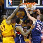 
              Cleveland's LeBron James, left,  dunks against Atlanta defenders Kent Bazemore, center,  and Mike Muscala, right, in the Eastern Conference Finals on Sunday, May 24, 2015, in Cleveland.  (Curtis Comptom/Atlanta Journal-Constitution via AP)
            