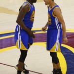 
              Golden State Warriors forward Draymond Green (23) and guard Stephen Curry (30) react during the second half of Game 6 of basketball's NBA Finals against the Cleveland Cavaliers, in Cleveland, Tuesday, June 16, 2015. (AP Photo/Paul Sancya)
            