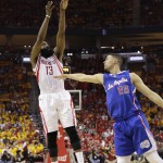 
              Houston Rockets' James Harden (13) shoots over Los Angeles Clippers' Austin Rivers (25) during the second half in Game 5 of the NBA basketball Western Conference semifinals Tuesday, May 12, 2015, in Houston. Houston won 124-103. (AP Photo/David J. Phillip)
            