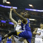 
              Golden State Warriors center Festus Ezeli (31) shoots against Memphis Grizzlies center Kosta Koufos (41) in the first half of Game 3 of a second-round NBA basketball Western Conference playoff series Saturday, May 9, 2015, in Memphis, Tenn. (AP Photo/Mark Humphrey)
            