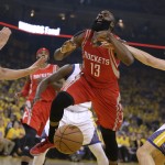 
              Golden State Warriors' Klay Thompson, right, fouls Houston Rockets' James Harden (13) during the first quarter of Game 1 of the Western Conference Finals Tuesday, May 19, 2015, in Oakland, Calif. At left is Warriors' Andrew Bogut. (AP Photo/Ben Margot)
            
