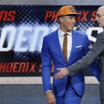               Devin Booker, left, talks with NBA Commissioner Adam Silver after being selected 13th overall by the Phoenix Suns during the NBA basketball draft, Thursday, June 25, 2015, in New York. (AP Photo/Kathy Willens)
            