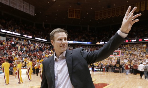 File- This Jan. 17, 2015, file photo shows Iowa State coach Fred Hoiberg waving to fans as he walks...
