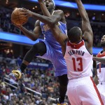 
              FILE- In this Dec. 5, 2014, file photo, Denver Nuggets guard Ty Lawson, left, is fouled by Washington Wizards center Kevin Seraphin (13), of France, during the first half of an NBA basketball game in Washington.  A person with direct knowledge of the deal said Monday, July 20, 2015, that the Denver Nuggets have agreed to send point guard Lawson to the Houston Rockets. (AP Photo/Nick Wass, File)
            