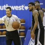 
              Referee Kevin Scott, left, officiates next to Orlando Magic Blue's Devyn Marble during the second half of an NBA summer league basketball game between Orlando and the Memphis Grizzlies , Tuesday, July 7, 2015, in Orlando, Fla. (AP Photo/John Raoux)
            
