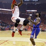 
              Houston Rockets forward Josh Smith (5) dunks as Los Angeles Clippers center DeAndre Jordan (6) looks on during the first half in Game 7 of the NBA basketball Western Conference semifinals Sunday, May 17, 2015, in Houston. (AP Photo/David J. Phillip)
            