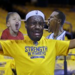 
              A Golden State Warriors fan wears a mask of Cleveland Cavaliers forward LeBron James, center, with photos of Golden State Warriors guard Stephen Curry, right, and Curry's daughter Riley before Game 2 of basketball's NBA Finals between the Warriors and the Cavaliers in Oakland, Calif., Sunday, June 7, 2015. (AP Photo/Ben Margot)
            