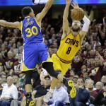 
              Golden State Warriors guard Stephen Curry (30) fouls Cleveland Cavaliers guard Matthew Dellavedova (8) as he shoots during the first half of Game 3 of basketball's NBA Finals in Cleveland, Tuesday, June 9, 2015. (AP Photo/Tony Dejak)
            