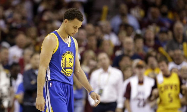 Golden State Warriors guard Stephen Curry (30) walks down the court with his head down in the closi...