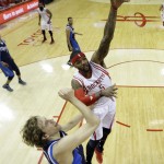 
              Houston Rockets' Josh Smith (5) shoots over Dallas Mavericks' Dirk Nowitzki  during the first half of Game 5 in the first round of the NBA basketball playoffs Tuesday, April 28, 2015, in Houston. (AP Photo/David J. Phillip)
            