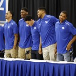 
              FILE - In this April 9, 2015, file photo, Kentucky coach John Calipari, right, applaudes as his NCAA college basketball players, from left, Willie Cauley-Stein, Andrew Harrison, Trey Lyles, Dakari Johnson, Devon Booker, Karl-Anthony Towns and Aaron Harrison stand during a news conference at the Joe Craft Center in Lexington, Ky., where they announced their intentions to enter the NBA draft. (AP Photo/James Crisp, File)
            