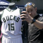
              A fan poses with a new Milwaukee Bucks basketball jersey at a summer block party Saturday, June 6, 2015, in Milwaukee. (AP Photo/Aaron Gash)
            