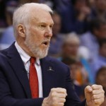               FILE - In this April 7, 2015, file photo, San Antonio Spurs coach Gregg Popovich gestures during the third quarter of an NBA basketball game against the Oklahoma City Thunder in Oklahoma City. Popovich will guide Team Africa against Team World in the NBA's first game in Africa, Aug. 1, in Johannesburg, the league announced Thursday, July 16, 2015.  (AP Photo/Sue Ogrocki, File)
            