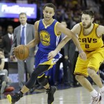 
              Golden State Warriors guard Stephen Curry (30) drives on Cleveland Cavaliers guard Matthew Dellavedova (8) during the second half of Game 4 of basketball's NBA Finals in Cleveland, Thursday, June 11, 2015. (AP Photo/Tony Dejak)
            