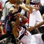 
              Washington Wizards forward Nene (42), from Brazil, passes the ball after a struggle with Atlanta Hawks guard Kyle Korver, top left, in the second half of Game 6 of the second round of the NBA basketball playoffs, Friday, May 15, 2015, in Washington. The Hawks won 94-91 to advance to the next round. (AP Photo/Alex Brandon)
            