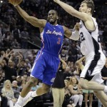 
              FILE - In this April 26, 2015, file photo, Los Angeles Clippers' Chris Paul (3) tries to score around San Antonio Spurs' Tiago Splitter during the second half of Game 4 in an NBA basketball first-round playoff series in San Antonio. Chris Paul will serve as captain of Team World against Team Africa in the NBA's first game in Africa. The game in scheduled for Aug. 1, in Johannesburg.  (AP Photo/Darren Abate, File)
            
