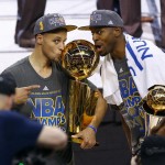 
              Golden State Warriors guard Stephen Curry, left, holds the championship trophy and Andre Iguodala holds the series MVP trophy as they celebrate winning the NBA Finals against the Cleveland Cavaliers in Cleveland, Wednesday, June 17, 2015. The Warriors defeated the Cavaliers 105-97 to win the best-of-seven game series 4-2. (AP Photo/Paul Sancya)
            