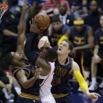 
              Atlanta Hawks forward Paul Millsap (4) is fouled by Cleveland Cavaliers center Timofey Mozgov (20) as Cleveland Cavaliers center Tristan Thompson (13) looks on during the second half in Game 1 of the Eastern Conference finals of the NBA basketball playoffs, Wednesday, May 20, 2015, in Atlanta. (AP Photo/David Goldman)
            