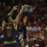               Cleveland Cavaliers guard J.R. Smith (5) shoots over Atlanta Hawks guard Dennis Schroder (17) during the first half in Game 1 of the Eastern Conference finals of the NBA basketball playoffs, Wednesday, May 20, 2015, in Atlanta. (AP Photo/John Bazemore)
            