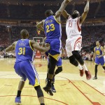 
              Houston Rockets guard James Harden (13) shoots over Golden State Warriors forward Draymond Green (23) during the first half in Game 3 of the Western Conference finals of the NBA basketball playoffs, Saturday, May 23, 2015, in Houston. (AP Photo/David J. Phillip)
            