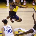 
              Cleveland Cavaliers forward LeBron James, top, shoots over Golden State Warriors forward Draymond Green during the first half of Game 5 of basketball's NBA Finals in Oakland, Calif., Sunday, June 14, 2015. (AP Photo/Eric Risberg)
            