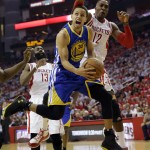 
              Golden State Warriors guard Stephen Curry (30) looks toward the basket before being fouled by Houston Rockets center Dwight Howard (12) during the first half in Game 3 of the NBA basketball Western Conference finals Saturday, May 23, 2015, in Houston. (AP Photo/David J. Phillip)
            