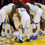 
              In this photo taken May 27, 2015, Golden State Warriors guard Klay Thompson, bottom, is checked on by teammates after taking a knee to his head from Houston Rockets forward Trevor Ariza during the second half of Game 5 of the NBA basketball Western Conference finals. The Warriors hope to get healthy and stay in tune over the next week before facing the Cleveland Cavaliers in the NBA Finals. Thompson needs to pass through the league's concussion protocol and Stepehen Curry is trying to get his aching body back at full strength.  (AP Photo/Tony Avelar, File
            