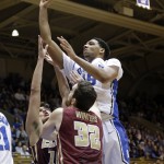 
              FILE - In this Dec. 15, 2014, file photo, Duke's Jahlil Okafor, top, shoots over Elon's Tony Sabato and Ryan Winters (32) during the first half of an NCAA college basketball game in Durham, N.C. The Los Angeles Lakers may snare Okafor at No. 2 in the NBA draft on Thursday, June 25, 2015. (AP Photo/Gerry Broome, File)
            
