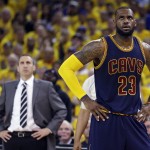 
              Cleveland Cavaliers forward LeBron James (23) stands on the court in front of head coach David Blatt during the first half of Game 2 of basketball's NBA Finals against the Golden State Warriors in Oakland, Calif., Sunday, June 7, 2015. (AP Photo/Ben Margot)
            