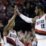 
              Portland Trail Blazers guard Damian Lillard, left, high fives teammate LaMarcus Aldridge during the second half in Game 4 of a first-round NBA basketball playoff series against the Memphis Grizzlies, Monday, April 27, 2015, in Portland, Ore. Lillard led the Trail Blazers in scoring with 32 points to beat the Grizzlies 99-92. (AP Photo/Don Ryan)
            