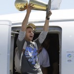 
              Golden State Warriors guard Stephen Curry yells as he lifts the Larry O'Brien championship trophy after the team landed in Oakland, Calif., Wednesday, June 17, 2015. The Warriors beat the Cleveland Cavaliers to win their first NBA championship since 1975. (AP Photo/Jeff Chiu)
            