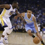               Denver Nuggets' Gary Harris, right, drives the ball against Golden State Warriors' Draymond Green during the first half of an NBA basketball game Wednesday, April 15, 2015, in Oakland, Calif. (AP Photo/Ben Margot)
            