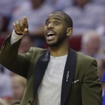
              Los Angeles Clippers' Chris Paul signals from the sidelines during the first half of Game 1 in a second-round NBA basketball playoff series against the Houston Rockets, Monday, May 4, 2015, in Houston. Chris Paul is out for game 1 with a strained left hamstring. (AP Photo/David J. Phillip)
            