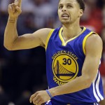 
              Golden State Warriors guard Stephen Curry (30) signals after making a 3-point basket against the Houston Rockets during the second half in Game 3 of the NBA basketball Western Conference finals Saturday, May 23, 2015, in Houston. (AP Photo/David J. Phillip)
            