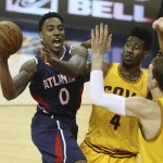 
              Atlanta Hawks' Jeff Teague (0) passes away from Cleveland Cavaliers' Iman Shumpert (4) and Timofey Mozgov during the second half in Game 3 of the Eastern Conference finals of the NBA basketball playoffs against the Cleveland Cavaliers Sunday, May 24, 2015, in Cleveland. (AP Photo/Ron Schwane)
            