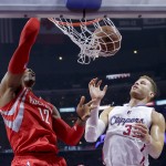 
              Houston Rockets center Dwight Howard, left, dunks as Los Angeles Clippers forward Blake Griffin watches during the first half of Game 6 in a second-round NBA basketball playoff series in Los Angeles, Thursday, May 14, 2015. (AP Photo/Jae C. Hong)
            