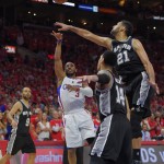 
              Los Angeles Clippers guard Chris Paul, second from left, shoots and makes a basket as San Antonio Spurs forward Tim Duncan, right, guard Danny Green and guard Tony Parker, of France, defend during the final seconds of Game 7 in a first-round NBA basketball playoff series, Saturday, May 2, 2015, in Los Angeles. The Clippers won 111-109. (AP Photo/Mark J. Terrill)
            