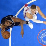 
              San Antonio Spurs center Boris Diaw, left, of France, shoots as Los Angeles Clippers forward Blake Griffin defends during the first half of Game 7 in a first-round NBA basketball playoff series, Saturday, May 2, 2015, in Los Angeles. (AP Photo/Mark J. Terrill)
            